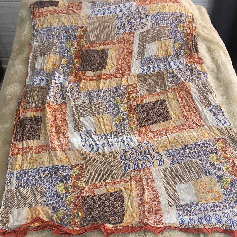 Patchwork Quilt with Orange and Blue Accents